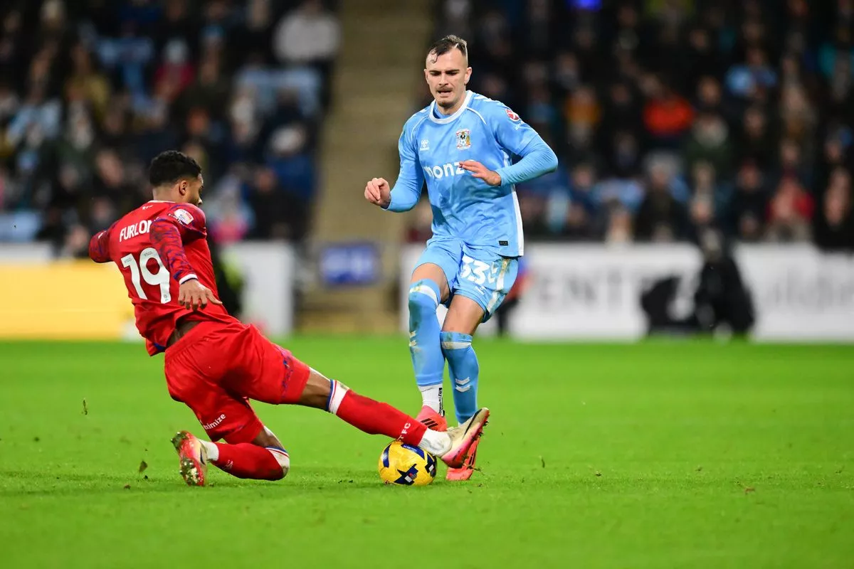 Ipswich Town defender Darnell Furlong (19) tackles Coventry City midfielder Miguel Angel Brau (33) 