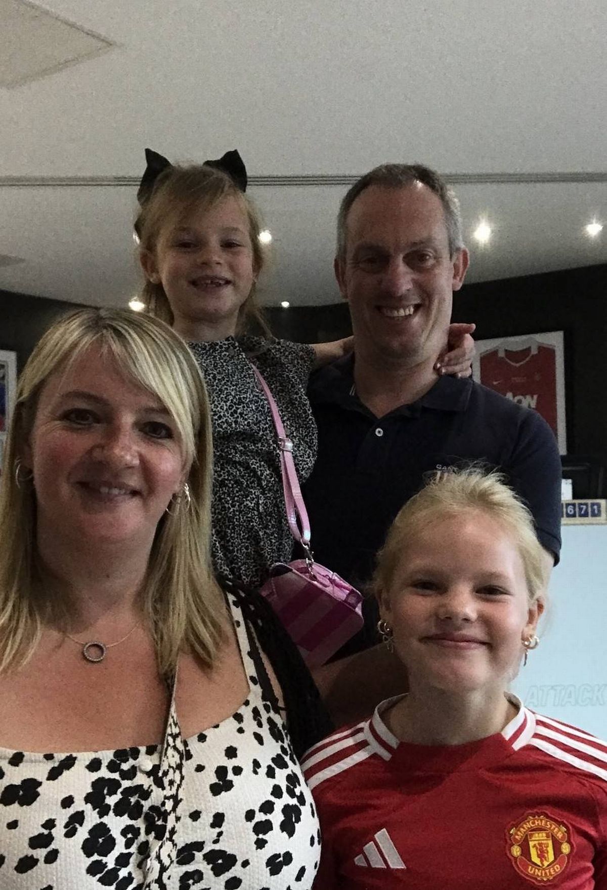 Kelly with her husband and their two daughters