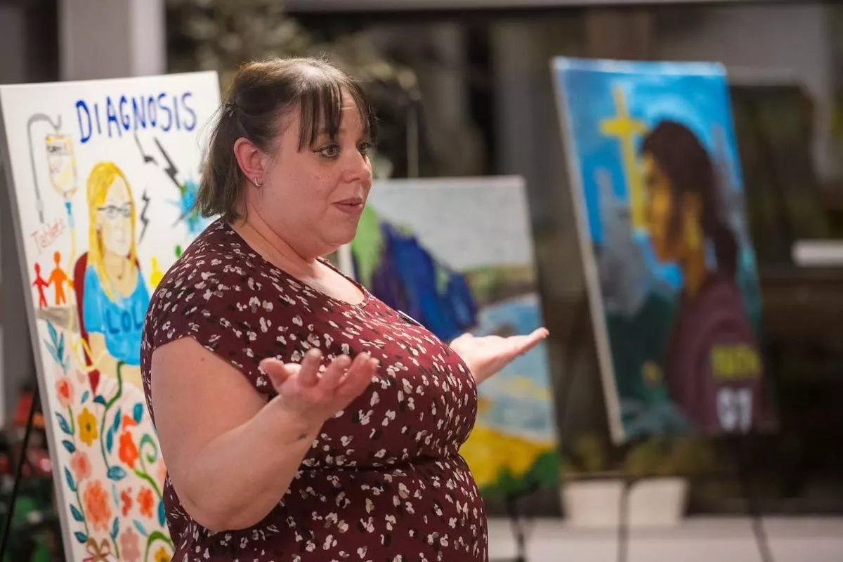 A woman with dark short hair gesturing