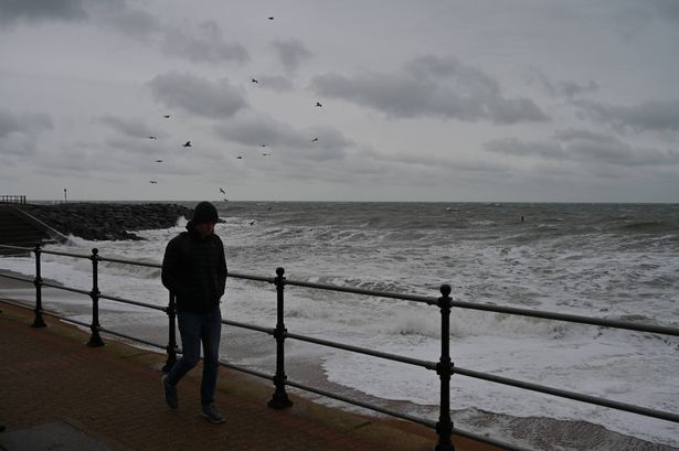 VENTNOR, ISLE OF WIGHT - NOVEMBER 22: A man walks along  the Esplanade on a grey blustery wet day on November 22, 2025 in Ventnor, Isle of Wight, England. (Photo by John Keeble/Getty Images)