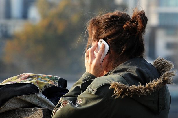 File image of a woman on a mobile phone