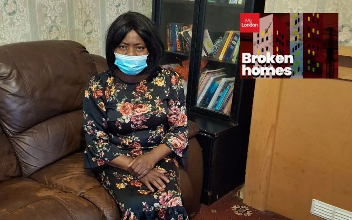 Ms Eniola sat on a sofa in her council home