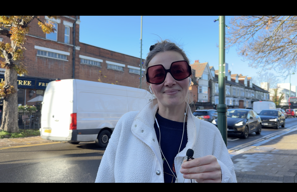 Zoey Leivers, who has just moved to Leytonstone, posing for a photo wearing big sunglasses 