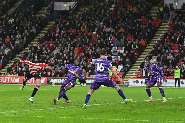 Sheffield United's Patrick Bamford heads in his side's third goal during the Sky Bet Championship match at Bramhall Lane