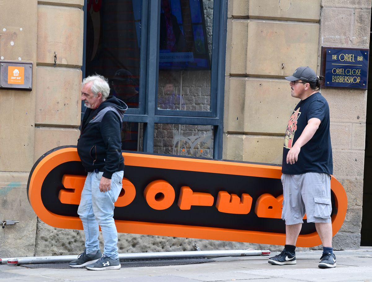 The Hooters sign being taken down on Water Street.(Pic Andrew Teebay).