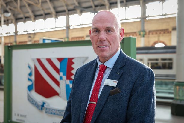 Phil James, Network Rail's Route Director for the North West next to the histroric plaque at Piccadilly Station. 