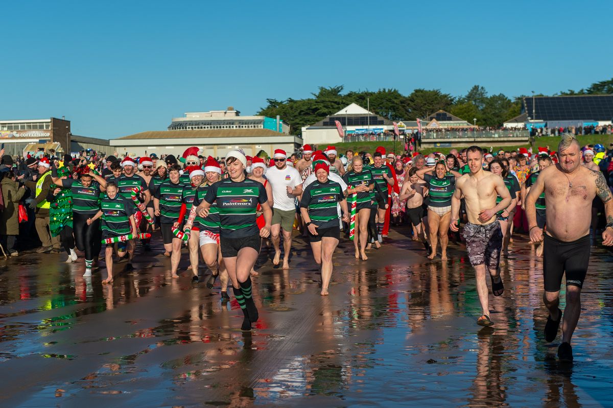 People running into the sea in Porthcawl on Christmas Day