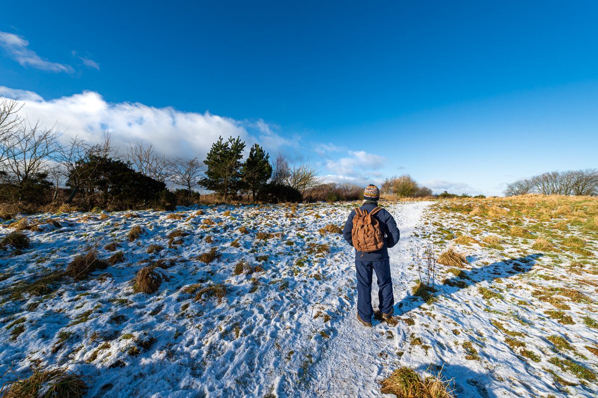 A picture of a man walking in snow in Scotland