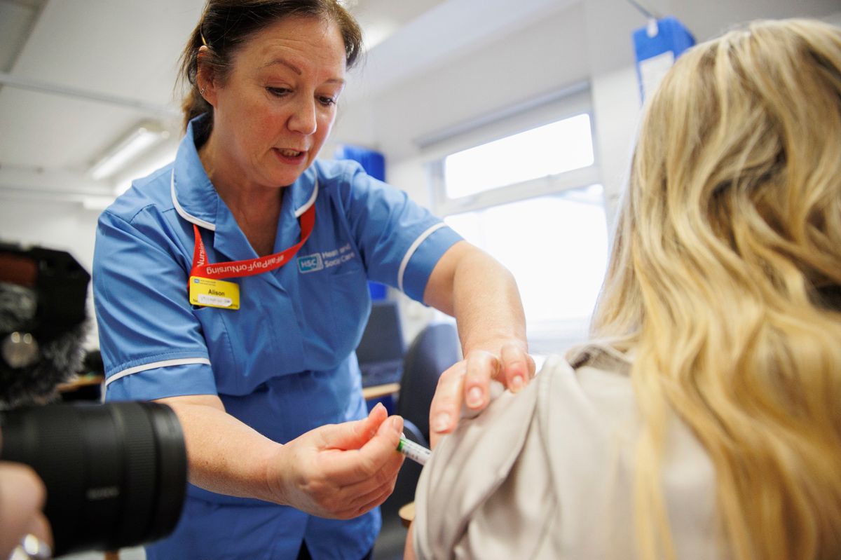 Vaccinator Alison administering the flu jab at the Ulster Hospital Vaccination Centre in Belfast