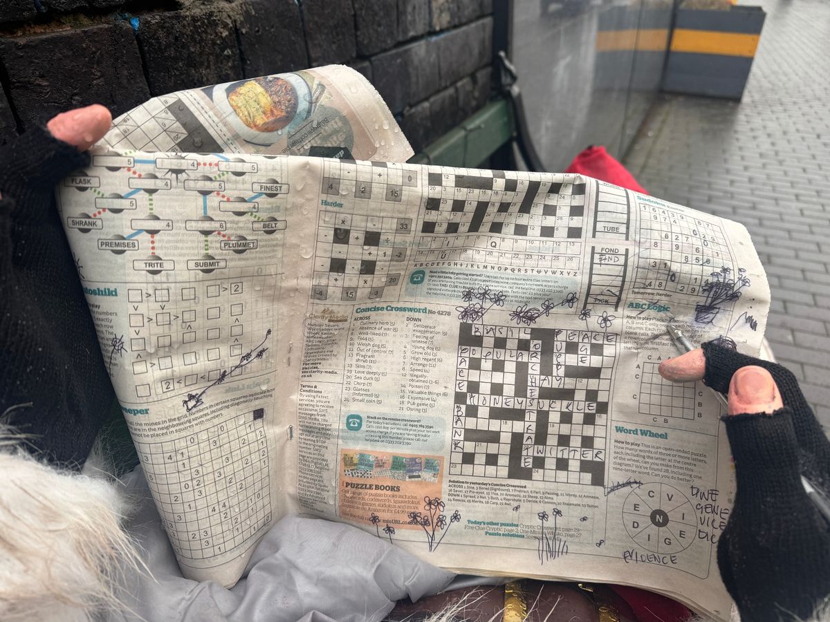 The Santa, tucked in a sleeping bag and wearing battered Tommy Hilfiger trainers, was holding a newspaper 