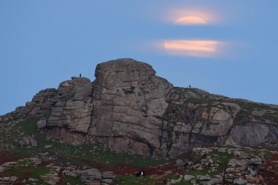 Dartmoor, Devon, UK. 7th Oct, 2025. Full supermoon appears through clouds over Hay Tor on Dartmoor, Devon. The first supermoon of 2025, October's full Moon is known as the Hunter's Moon but it is also this year's Harvest Moon. The Harvest Moon is the name given to the full Moon that rises closest to the autumn equinox, traditionally a time for gathering crops. It also rises around sunset for several evenings in succession creating extra light for farmers working outside. Credit: nidpor/Alamy Live News