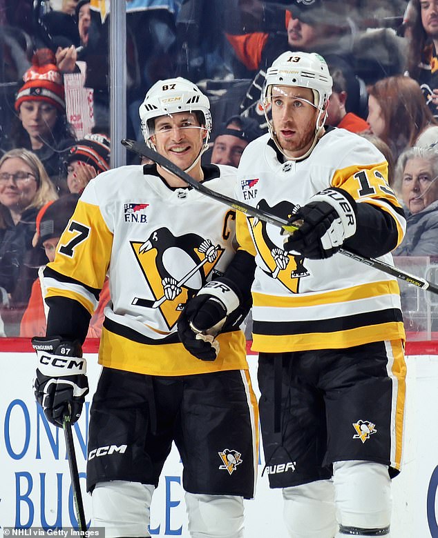 Kevin Hayes #13 of the Pittsburgh Penguins celebrates his third period goal against the Philadelphia Flyers with Sidney Crosby #87 at the Xfinity Mobile Arena on December 1