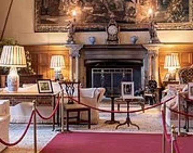 This photo from the Sandringham official website shows the same fireplace - with the same clock and ornaments above and, on the left, the faint outline of the hidden door to room where King George V recorded first Christmas broadcast