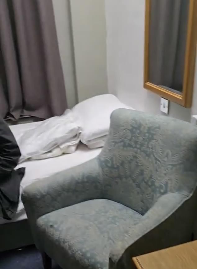 Sue Reid was shown a bedroom (pictured) now shared by two Middle Eastern migrants, where the luxurious bed of yesteryear has been replaced with two Home Office singles with cheap, spongy mattresses