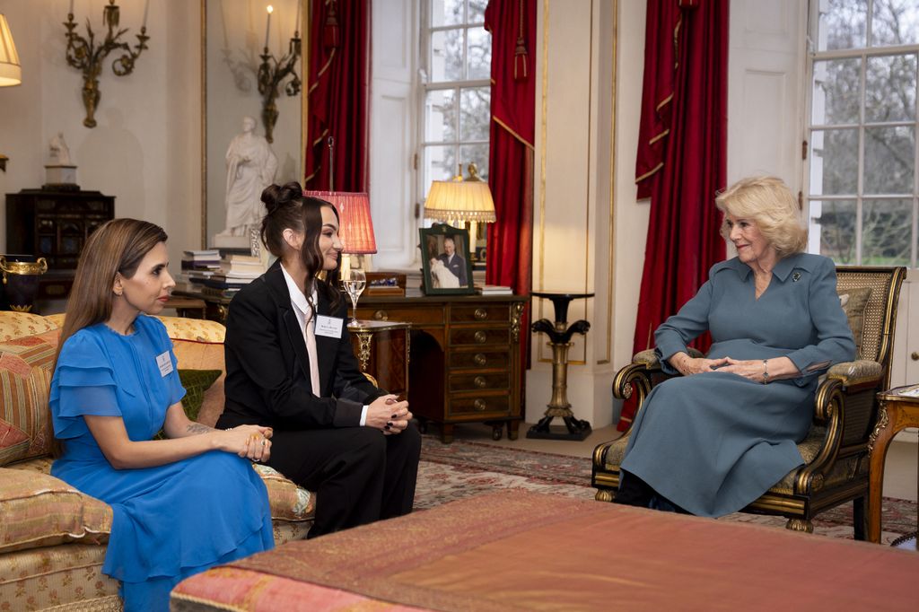 Queen Camilla in grey dress sitting in Clarence House