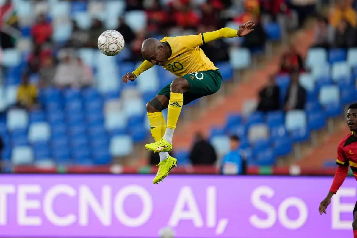 South Africa's Khuliso Mudau heads the ball during the Africa Cup of Nations group B soccer match between Angola and South Africa in Marrakech, Morocco, Monday, Dec. 22, 2025. (AP Photo/Themba Hadebe)
