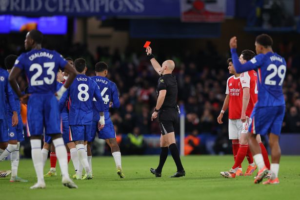Referee Anthony Taylor brandishing a red card
