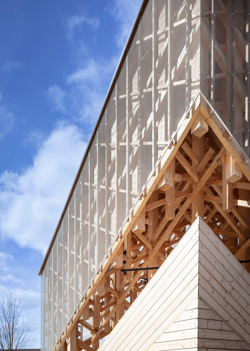 crystalline timber canopy inspired by snow fractals becomes a gathering space in finland