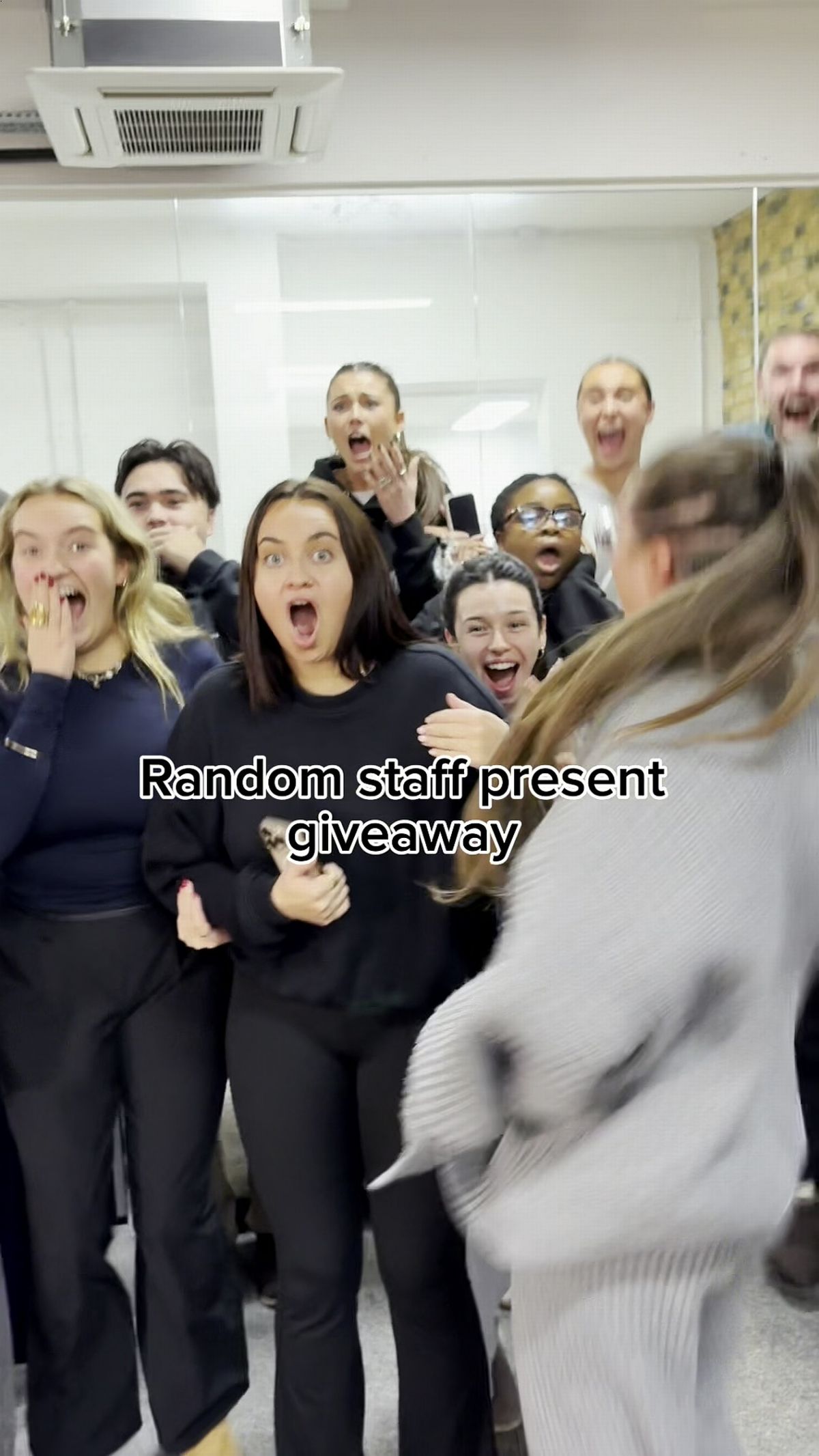 Her co-workers cheered as she opened the envelope