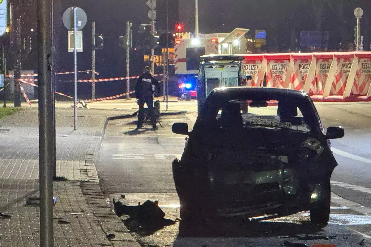 A wrecked vehicle is seen where a 32-year-old man from Azerbaijan, crashed his car into a bus stop Monday, Dec. 22, 2025, in Giessen, Germany. (AP Photo/Tom Moldoveau)