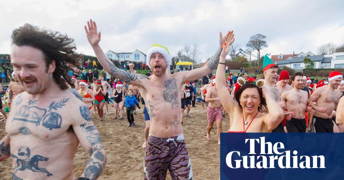 Christmas Eve swims and an underground mass: photos of the day – Wednesday - The Guardian