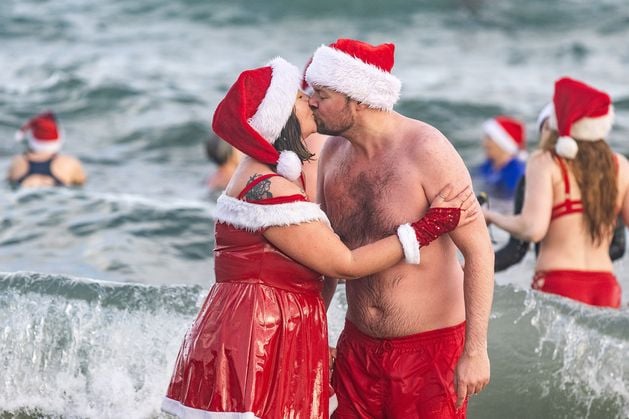 In pictures: Swimmers brave the cold for charity Christmas Eve splash at Helen’s Bay