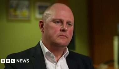 Paul Nowak, wearing a black suit and white shirt