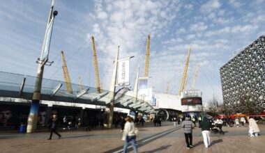 GettyImages 2200386037 showing a diverse group of business professionals in a modern office setting discussing strategic p...