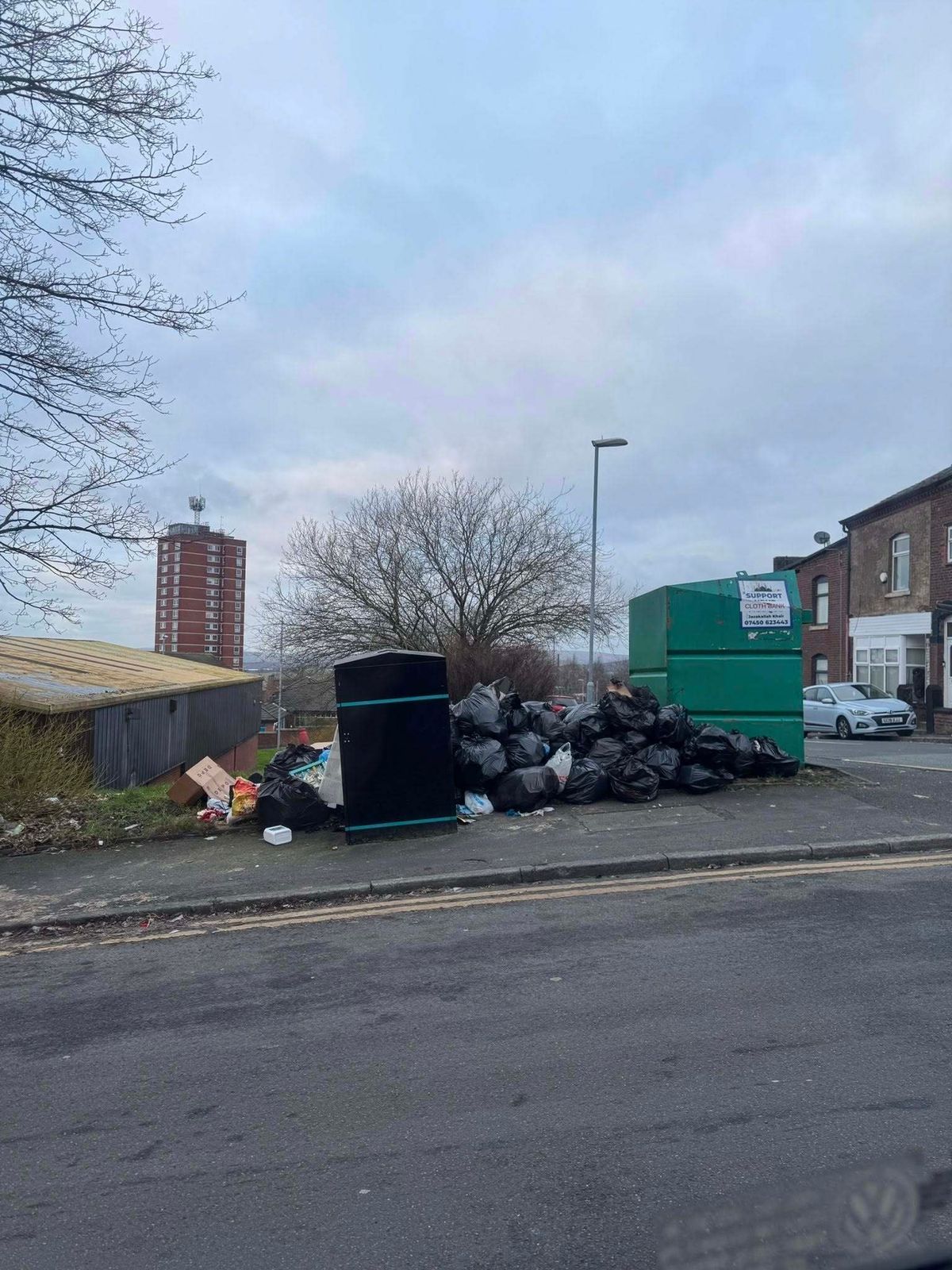 A photo by a local resident shows the area next to the bin piled high with household rubbish bags. 