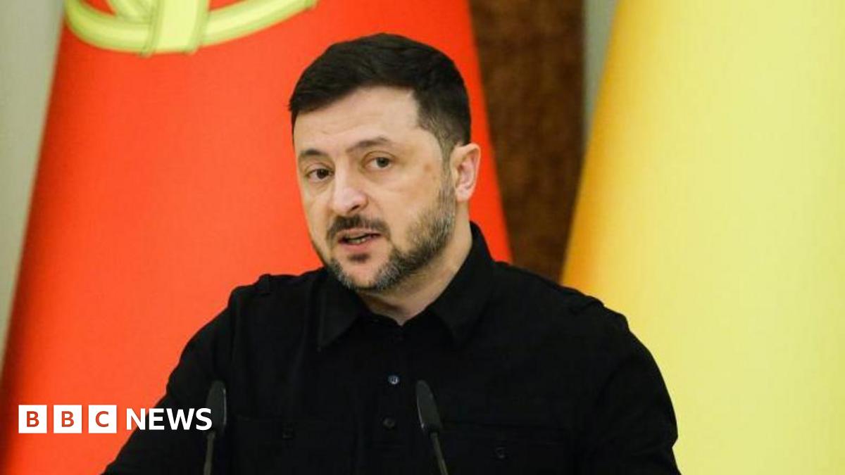 Ukrainian President Volodymyr Zelensky speaks during a joint press conference with Portuguese Prime Minister Montenegro following their meeting in Kyiv, Ukraine, 20 December 2025. he is dressed in a black shirt and in the background the Portuguese and the Ukrainian flags can be seen