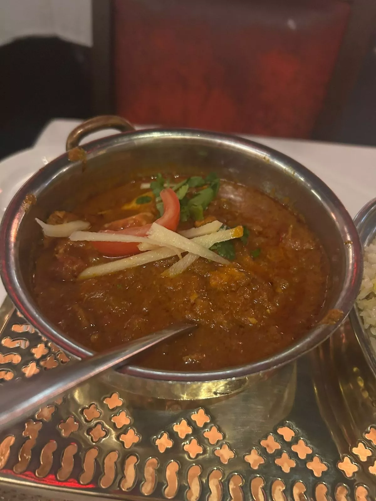 The chicken jhol consists of marinated chicken cooked in a spicy sauce of tomatoes, ginger, garlic, fresh coriander and fenugreek