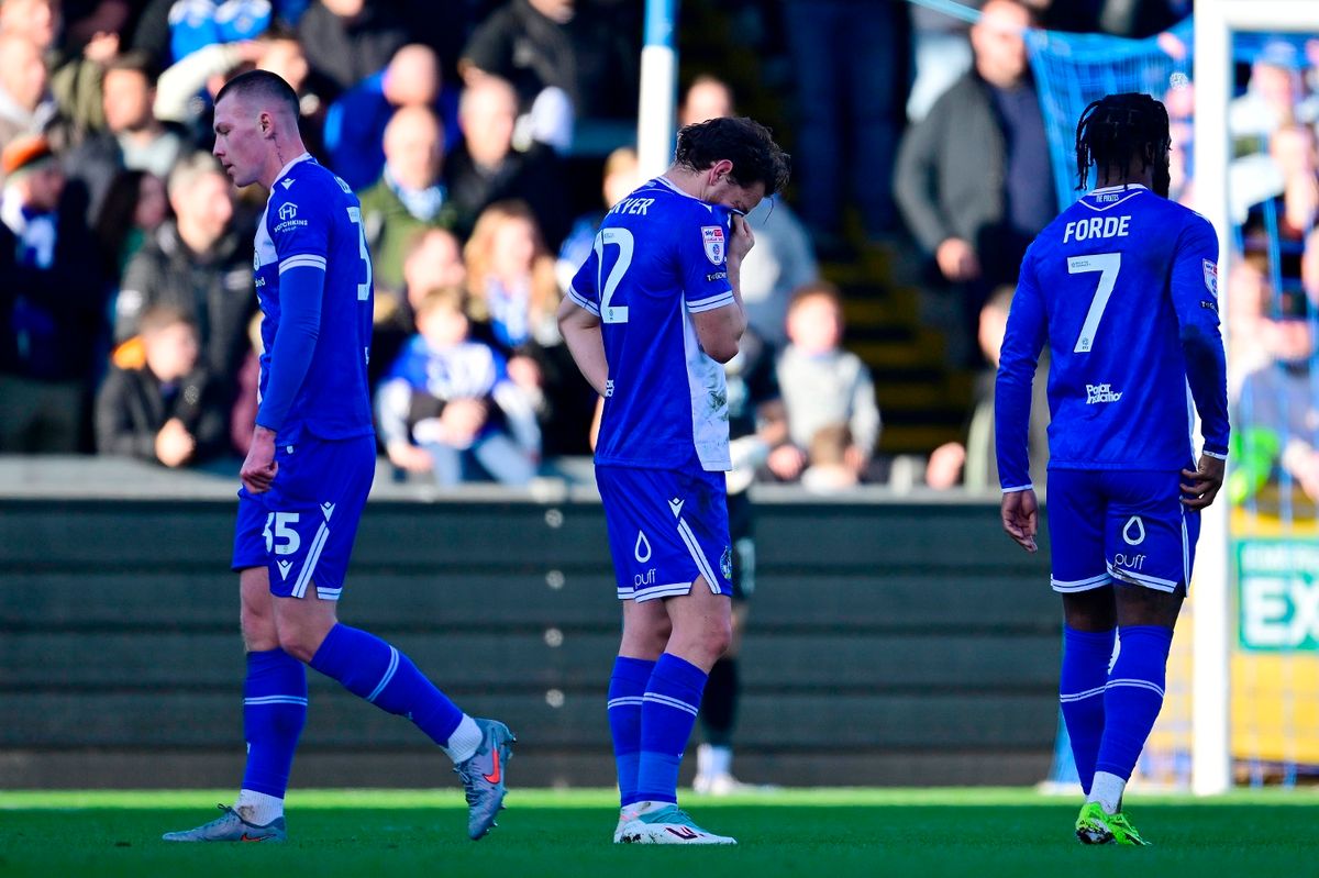 Tom Lockyer of Bristol Rovers (C) looks dejected after Kacper Lopata of Bristol Rovers (L) is shown a red card by Referee,  Aaron Bannister  during the Sky Bet League 2 Match between Bristol Rovers and Swindon Town at Memorial Stadium on 13 December 2025. Photo: Tom Sandberg/PPAUK
