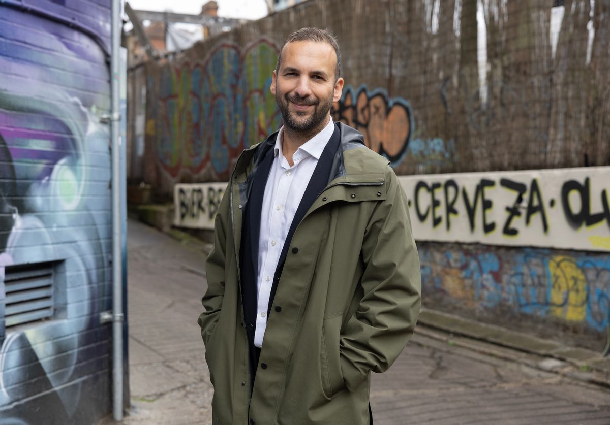 Leader of the Green Party, Zack Polanski standing in front of graffiti