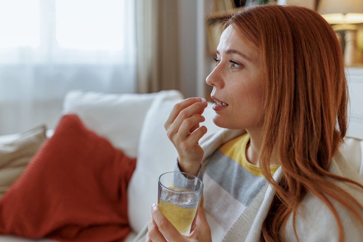 Woman taking a supplement