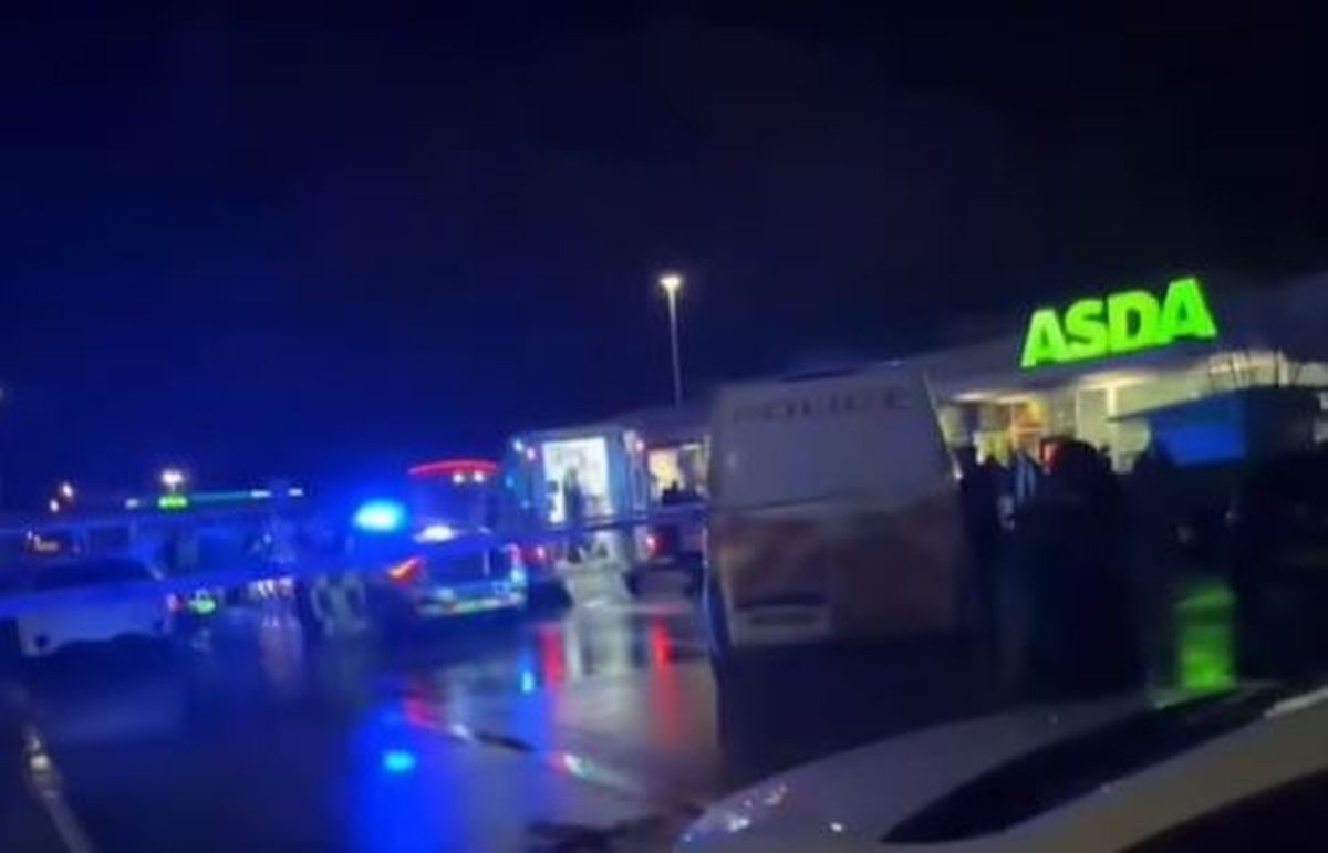Emergency services taped off part of the car park at the supermarket in Oldham