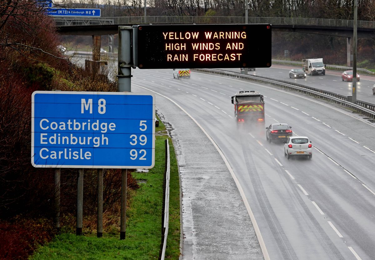 Warning sign on the M8 ahead of the arrival of Storm Bram that reads Yellow Warning, High Winds And Rain Forecast.