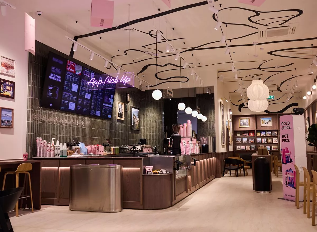 Pink interior of the new shop, angle showing the bar and seating area