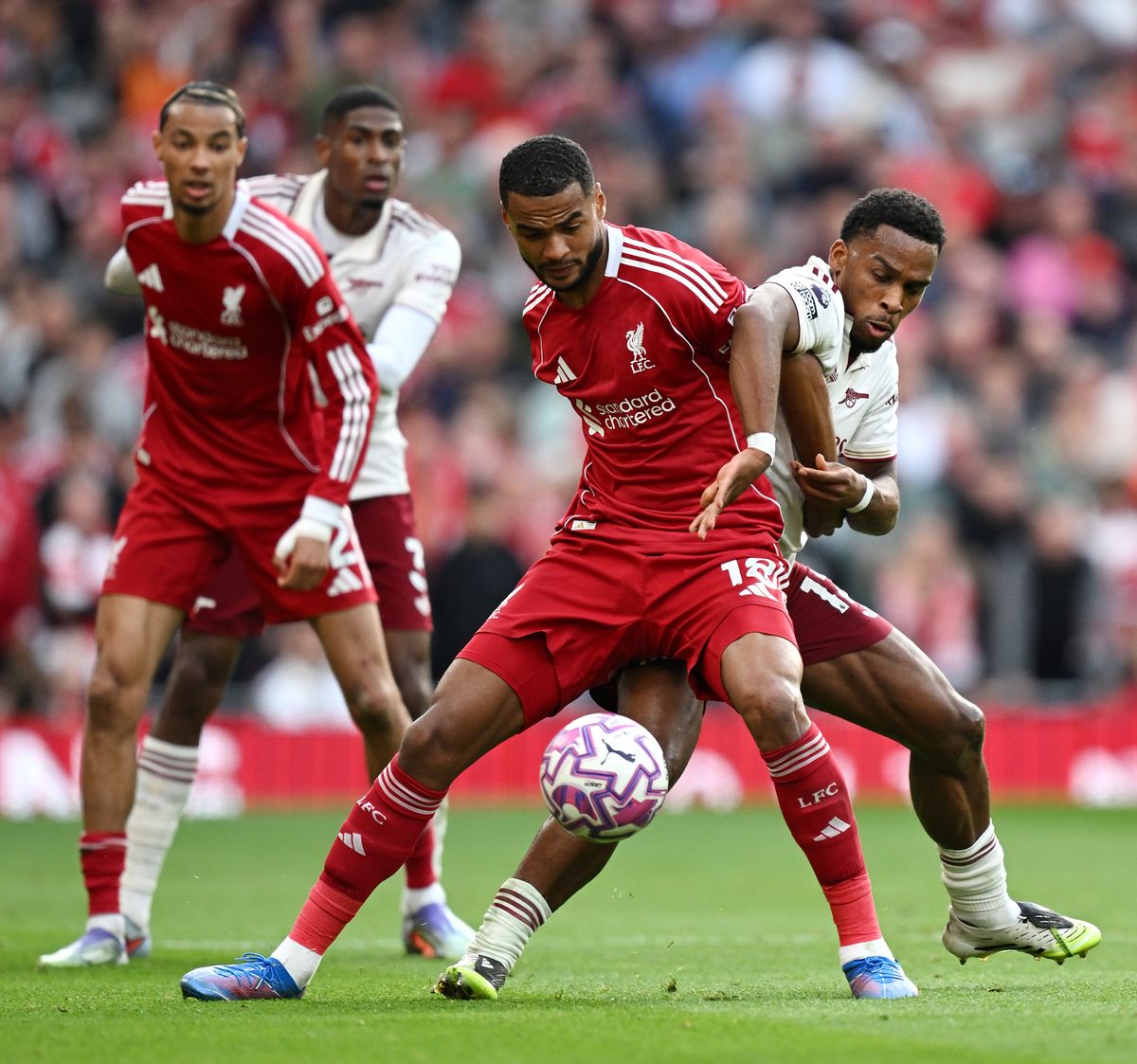 Cody Gakpo of Liverpool is challenged by Jurrien Timber of Arsenal during the Premier League match between Liverpool and Arsenal at Anfield