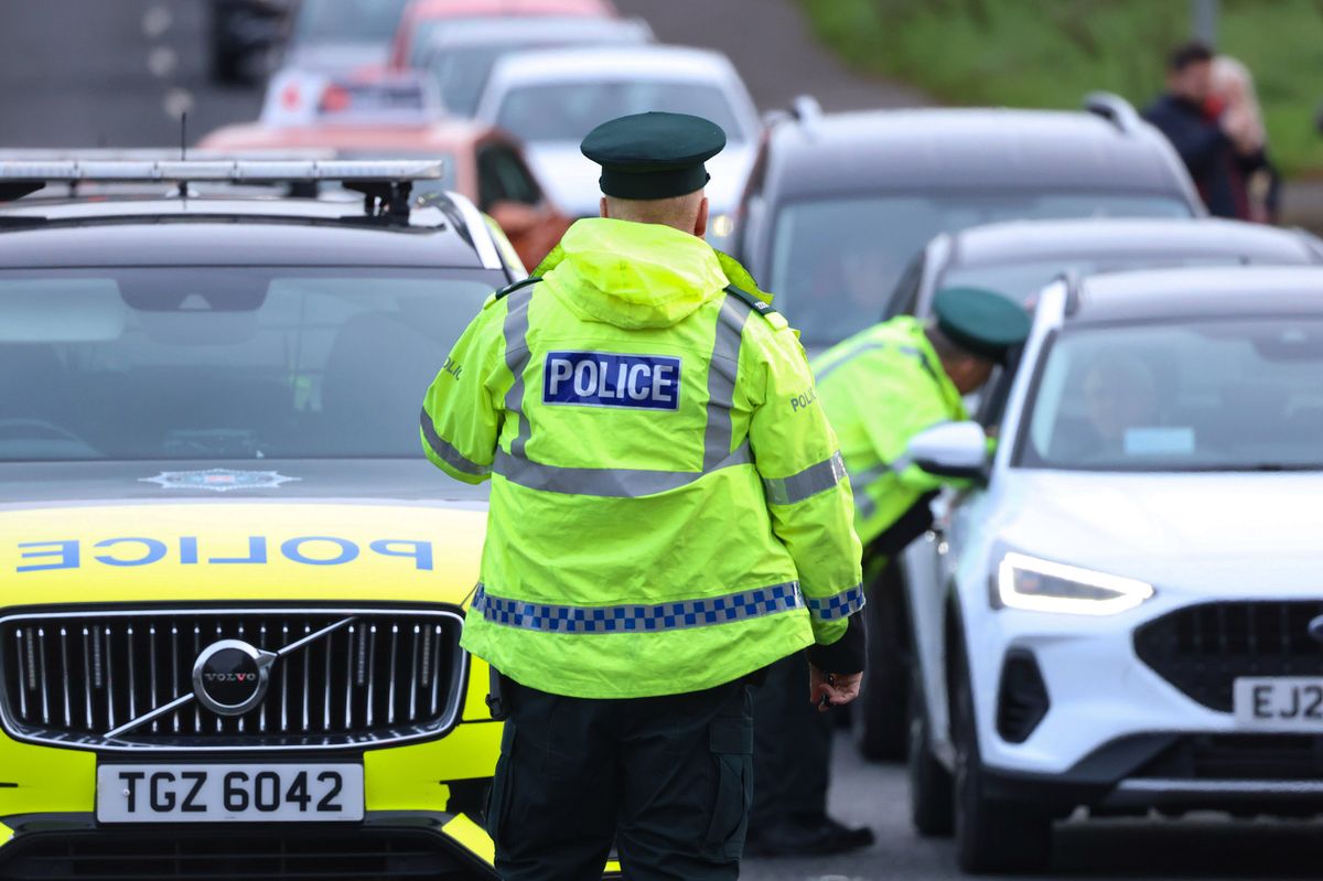 Stock image of PSNI officers stopping cars at a checkpoint 