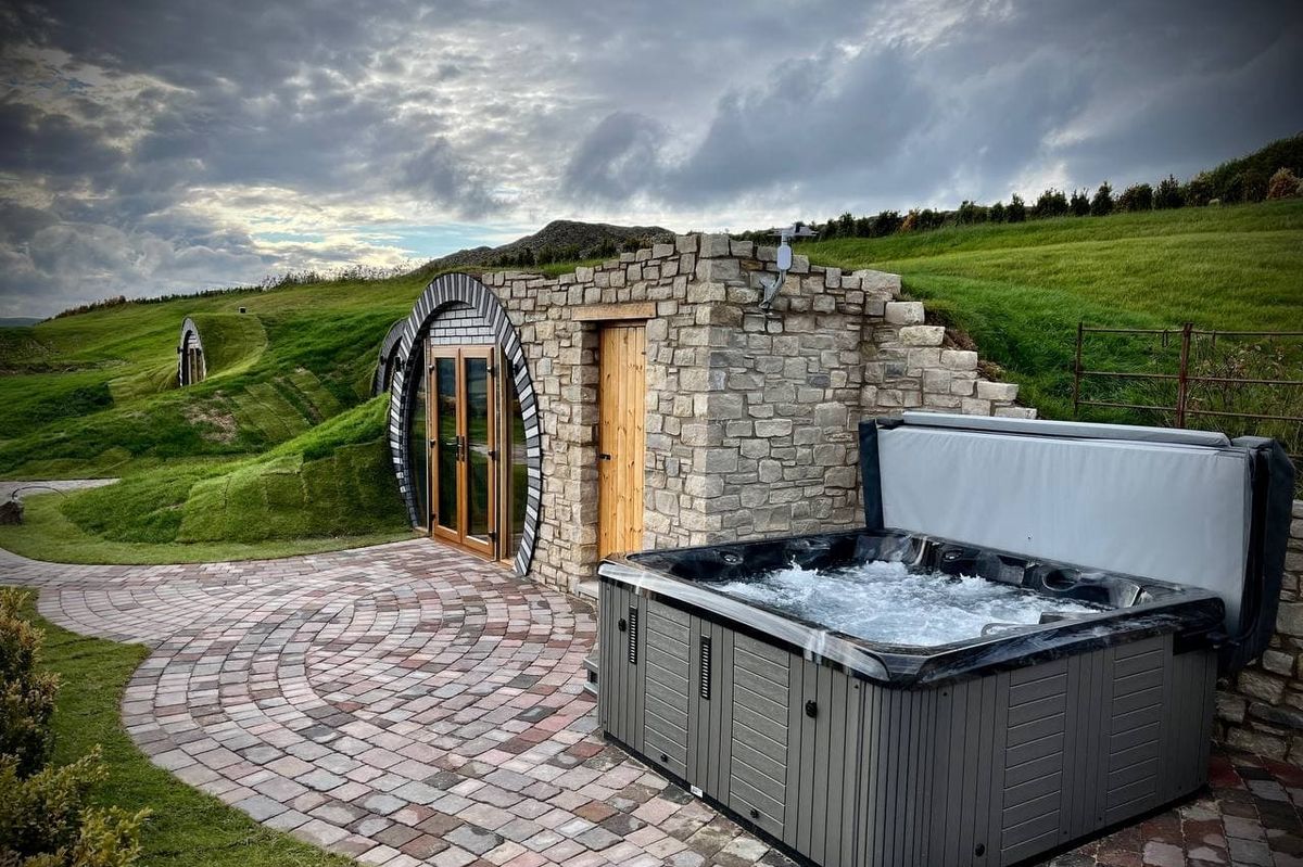 Hobbit House holiday homes, with hot tub outside the entrance of each hub
