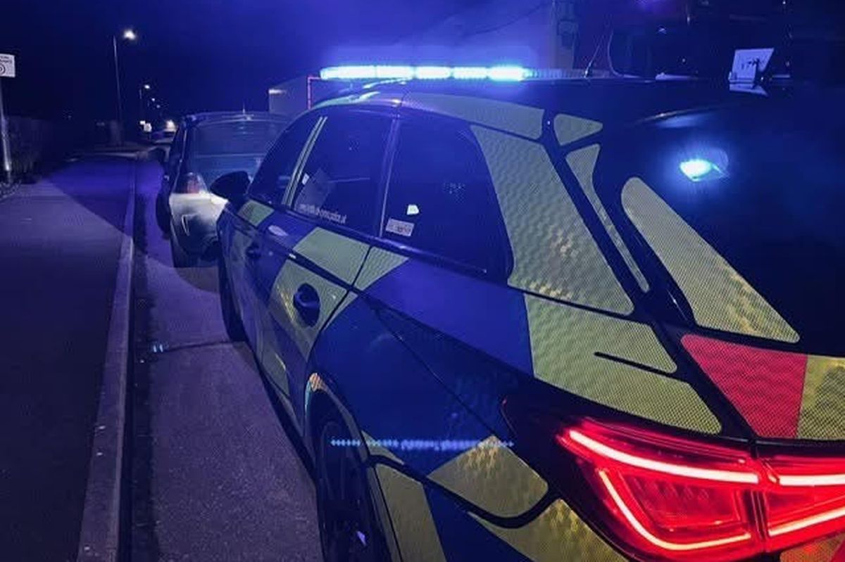 police vehicle lit up at night