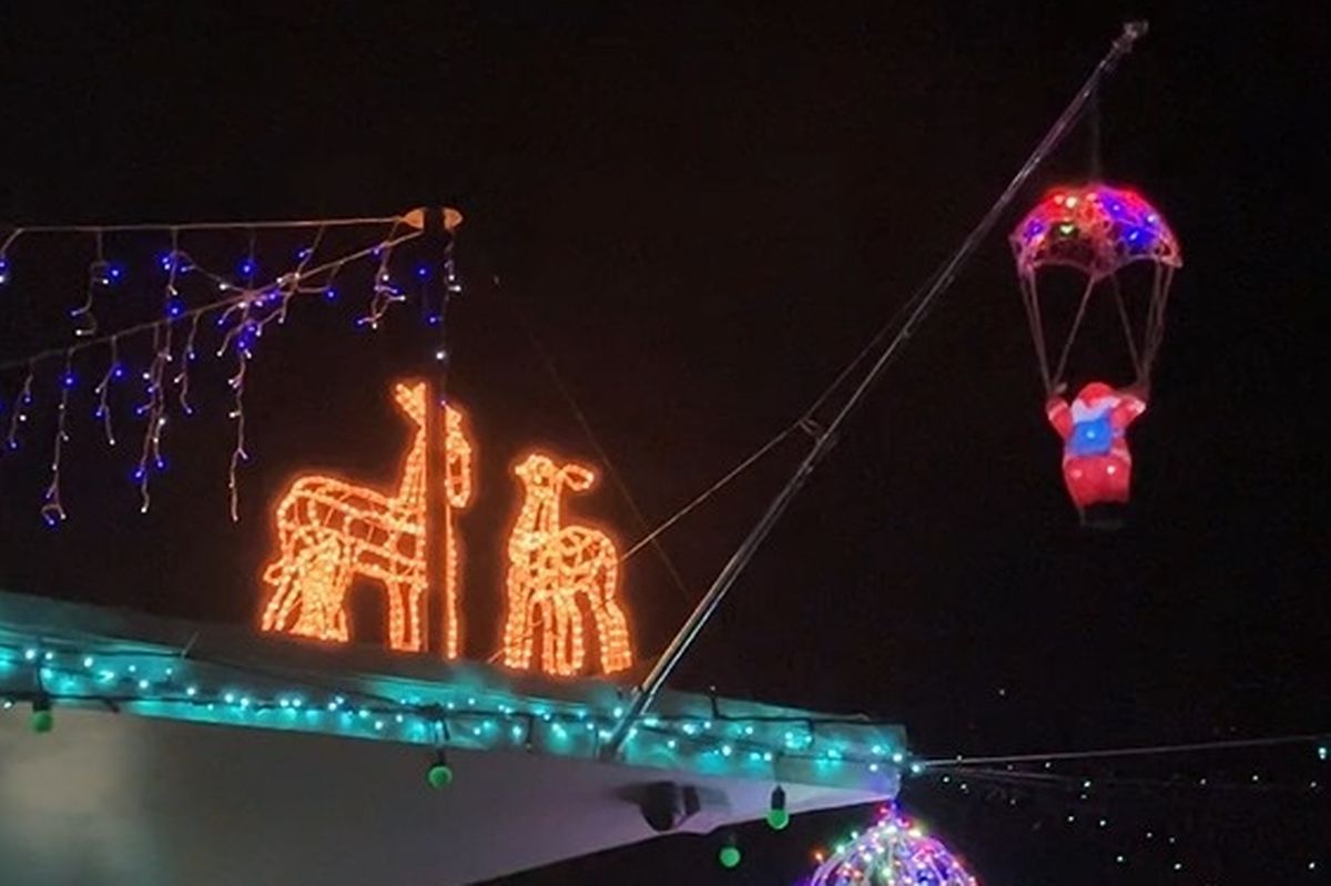 Christmas lights on a pub roof in the shape of glowing deer, and a parachuting Santa 