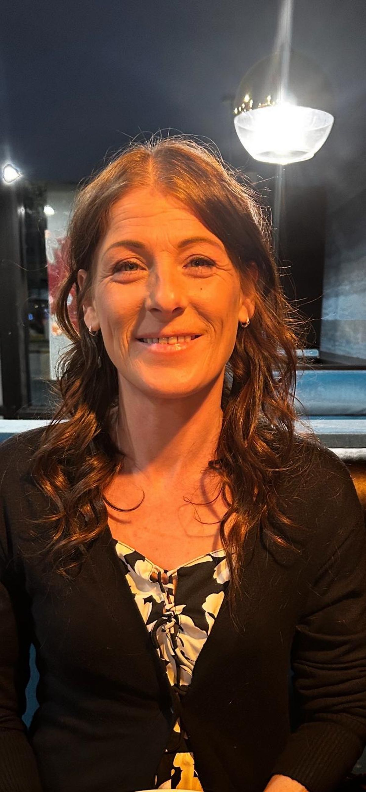 A woman with brown hair smiling