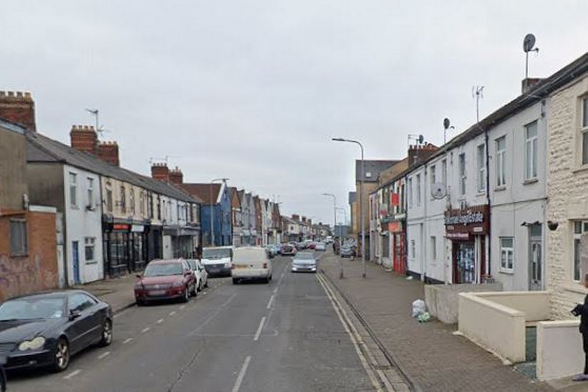 A street with shops and parked cars