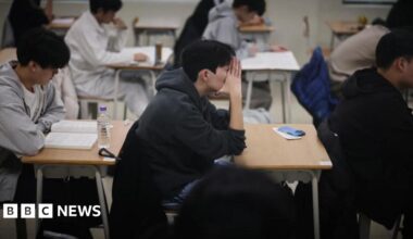 Students wait for the start of the annual college entrance examinations, also known as Suneung, at an exam hall in Seoul