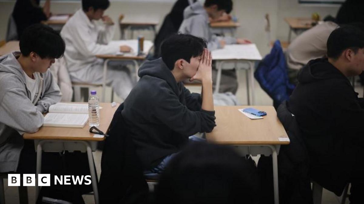 Students wait for the start of the annual college entrance examinations, also known as Suneung, at an exam hall in Seoul