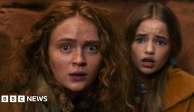 Sadie Sink and Nell Fisher looking frightened inside a cave