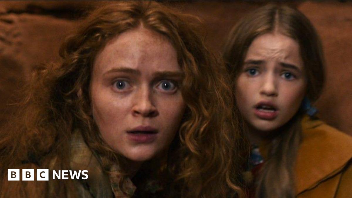 Sadie Sink and Nell Fisher looking frightened inside a cave