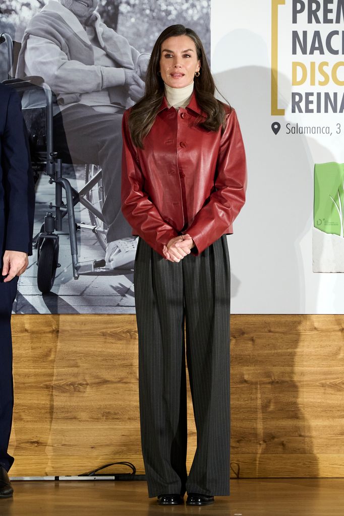Queen Letizia of Spain in red leather jacket and striped trousers