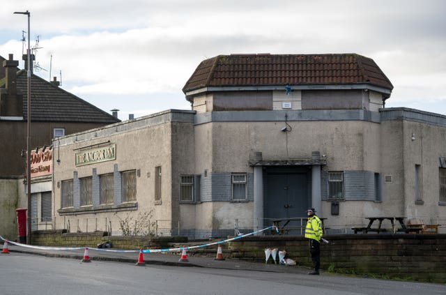 Police cordon and a policeman outside the Anchor Inn
